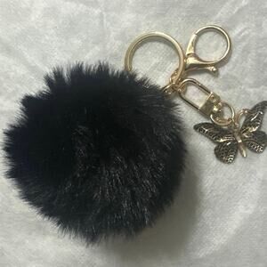 Black Pom Pom key chain or bag charm w/black & gold butterfly Charm. Brand New